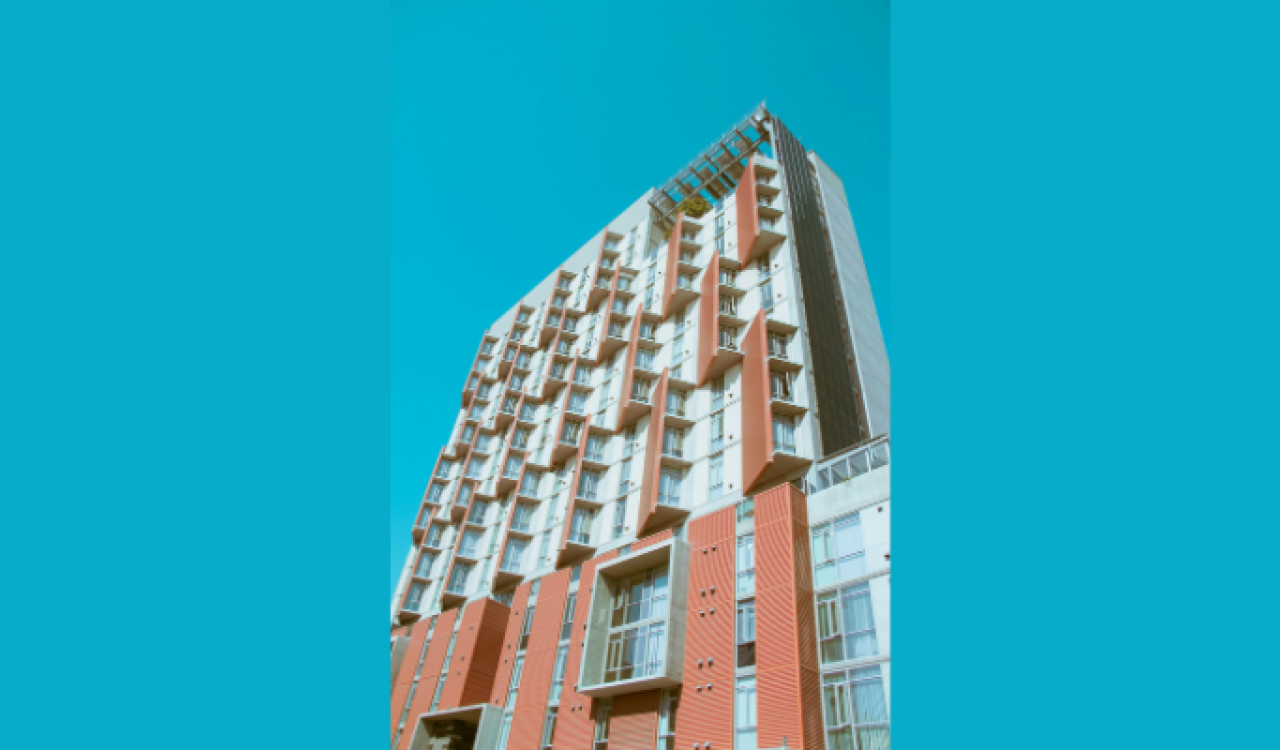 Low-angle shot of apartment building on light blue background