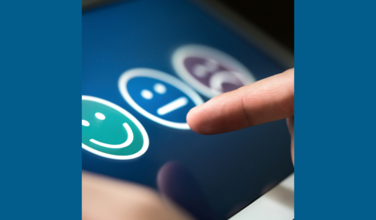 Finger pointing to three different face emojis on dark blue background