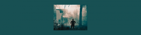 Firefighter looking at burned house