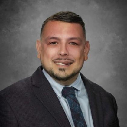 Eddie Valero headshot in suit and tie