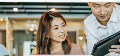 Asian man and woman looking at a tablet
