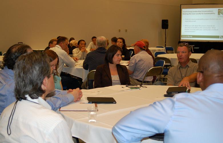 Participants engaged in small group discussions about local sustainability projects