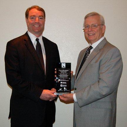 League of California Cities Executive Director Chris McKenzie (right) presents the Beacon Award for local sustainability leadership to San Rafael City Council Member Damon Connolly (left) during the 2013 League of California Cities Annual Conference. 
